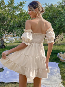 Woman wearing apricot color short dress with short sleeves and bow