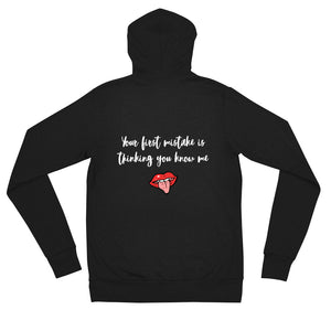 Black color zip hoodie that says Your First Mistake Is Thinking You Know Me with a picture of a tongue sticking out