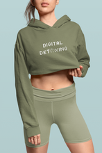 Load image into Gallery viewer, Woman wearing military green crop top hoodie that says &quot;Digital Detoxing&quot;