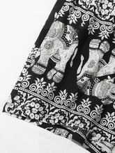 Load image into Gallery viewer, Black and white shorts with elephants print