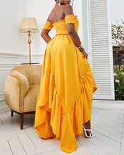 Load image into Gallery viewer, Woman wearing long yellow flowy strapless halter dress