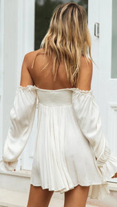 Woman wearing white off-shoulder short flowy dress