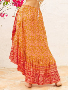 Woman wearing long orange flowy boho skirt
