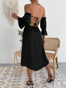 Woman wearing off-shoulder black mid length dress