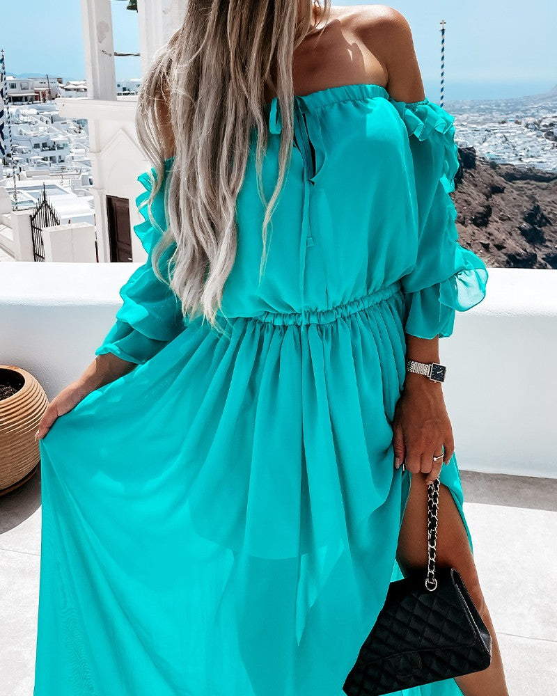 Woman wearing long aqua color sheer dress with sleeves