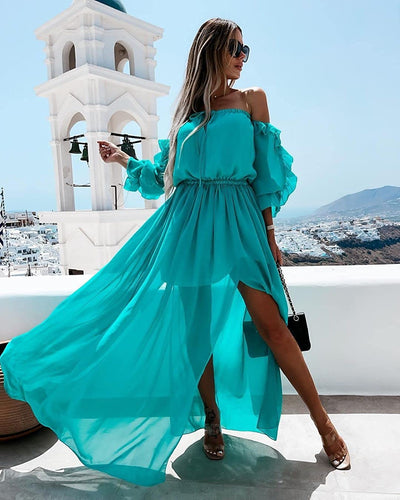 Woman wearing long aqua color sheer dress with sleeves