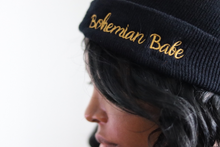Load image into Gallery viewer, Woman wearing black beanie that says Bohemian Babe in gold letters