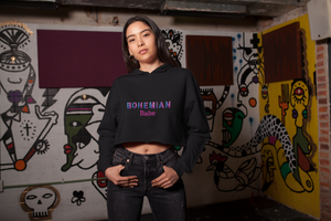 Woman wearing black crop top hoodie that says "Bohemian Babe"