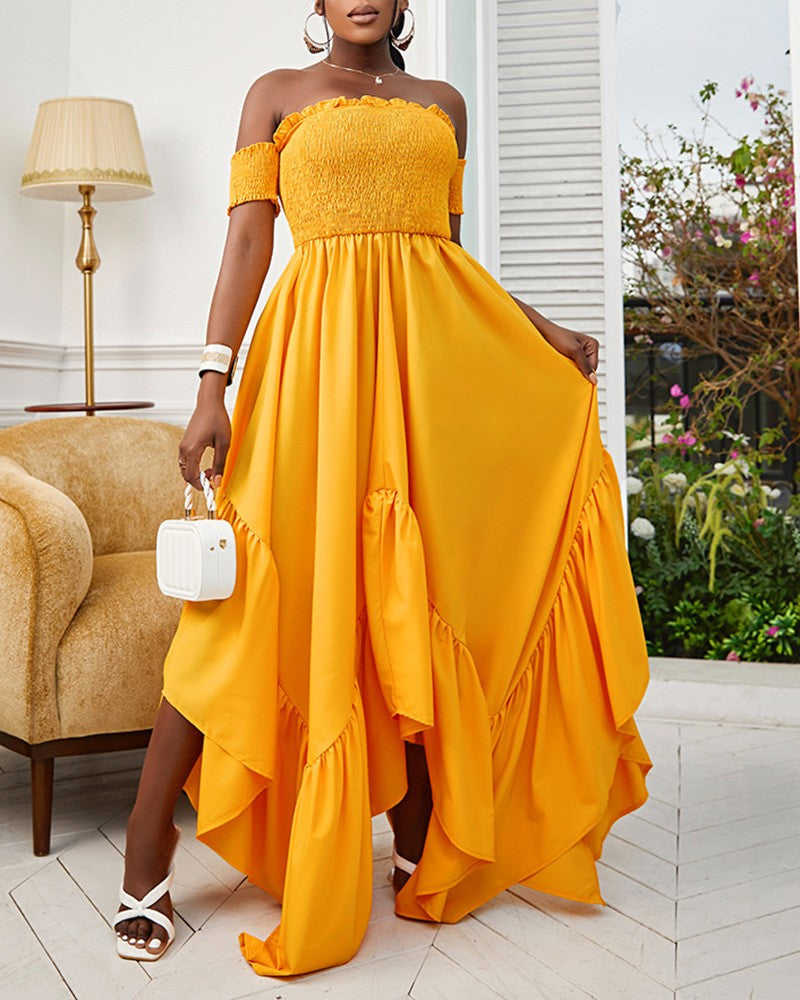 Woman wearing long yellow flowy strapless halter dress