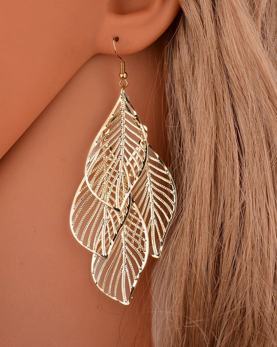 A group of four gold leaves earrings