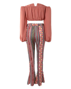 Pink off-shoulder top and multicolor pants