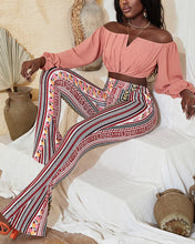 Load image into Gallery viewer, Woman wearing pink off-shoulder top and multicolor pants