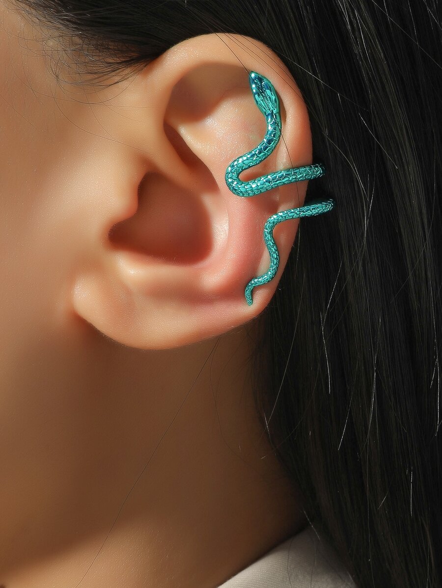 Woman wearing green snake ear cuff