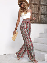 Load image into Gallery viewer, Woman wearing multicolor loose pants with boho design