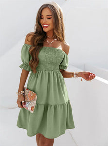 Woman wearing off-shoulder short flowy green dress