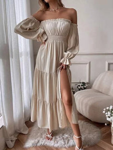 Woman wearing beige off-shoulder long sleeve flowy dress