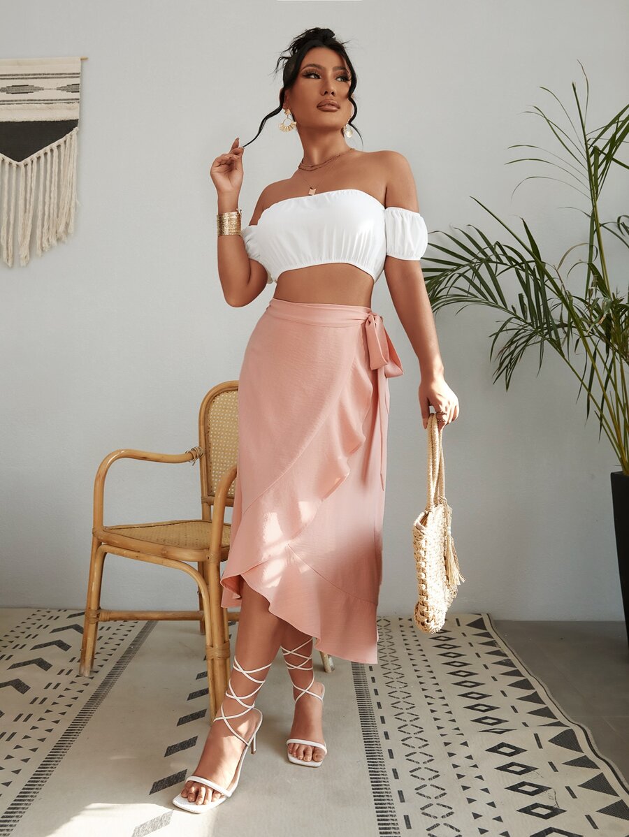 Woman wearing white off-shoulder top and pink long skirt