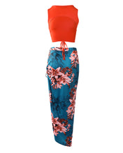Load image into Gallery viewer, Woman wearing orange halter top and long dark turquoise skirt with split