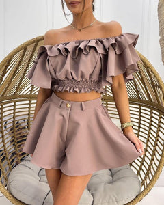 Woman wearing off-shoulder mauve color ruffle top and shorts