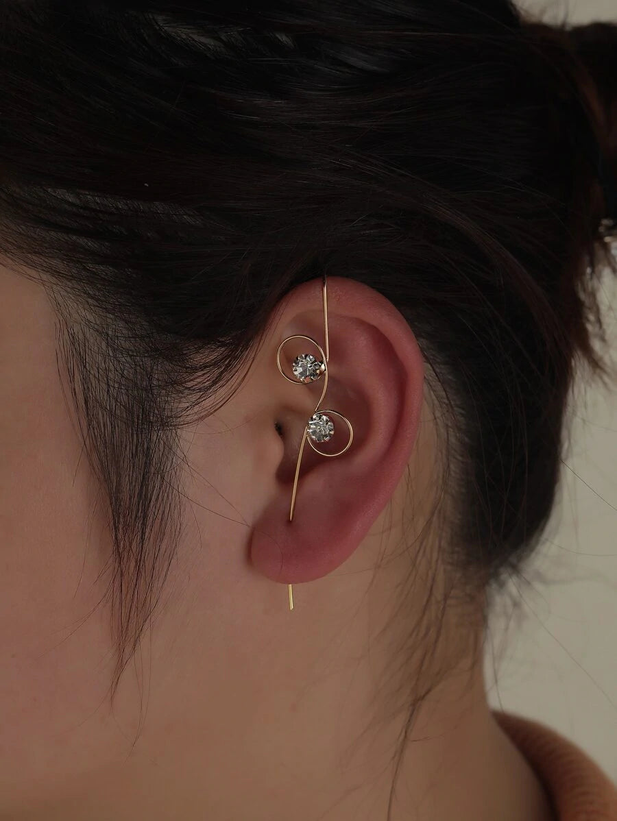 Woman wearing gold wrap hook earring with rhinestones