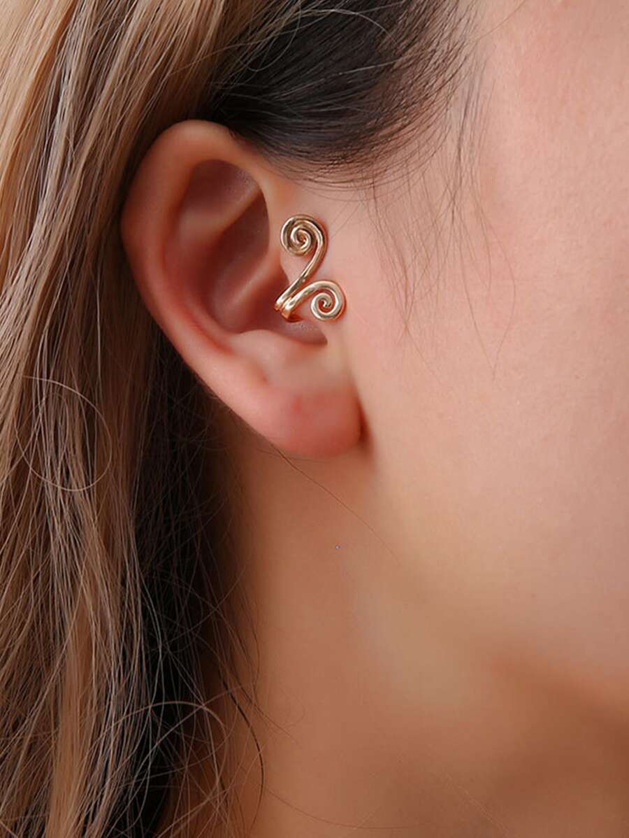 Woman wearing gold spiral ear cuff