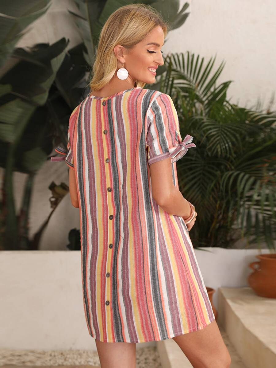 Woman wearing short multicolor stripe dress