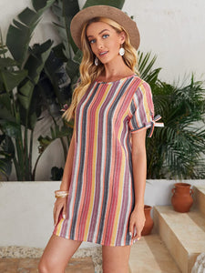 Woman wearing short multicolor stripe dress