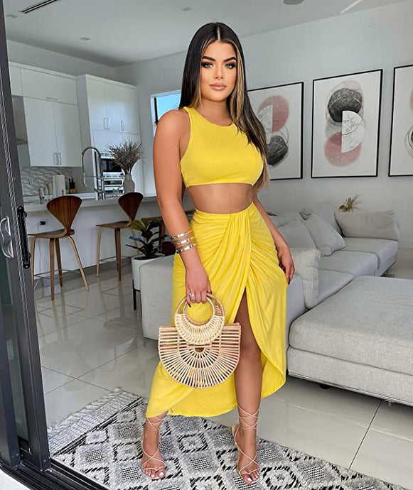 Woman wearing yellow crop top and long skirt