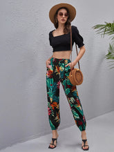 Load image into Gallery viewer, Woman wearing multicolor tropical print pants