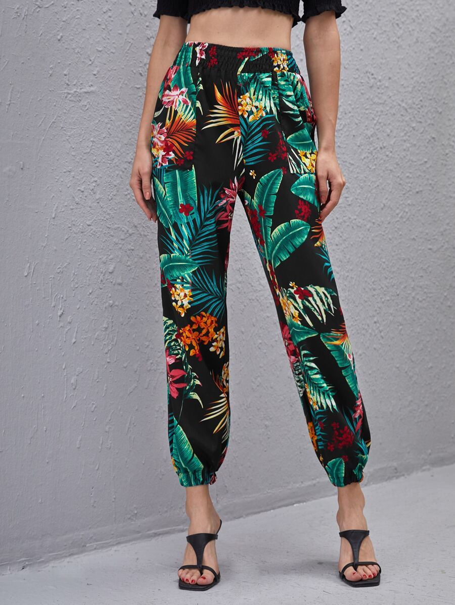 Woman wearing multicolor tropical print pants