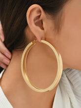 Load image into Gallery viewer, Woman wearing big gold hoop earrings