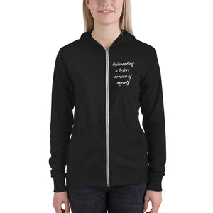 Woman wearing black hoodie that says "Reinventing a better version of myself" on front