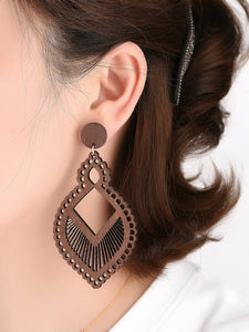 Woman wearing wood drop earrings
